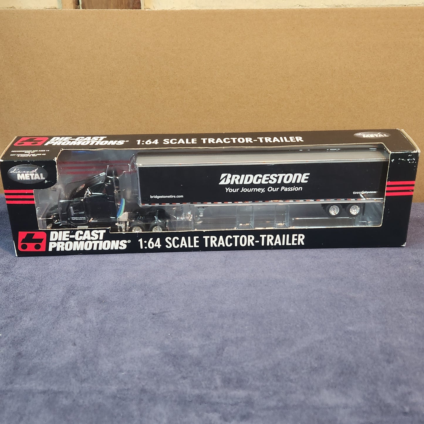 Diecast Promotions 1:64 Bridgestone Volvo VNL 630 Mid Roof with Dry Goods Trailer DCP #33658