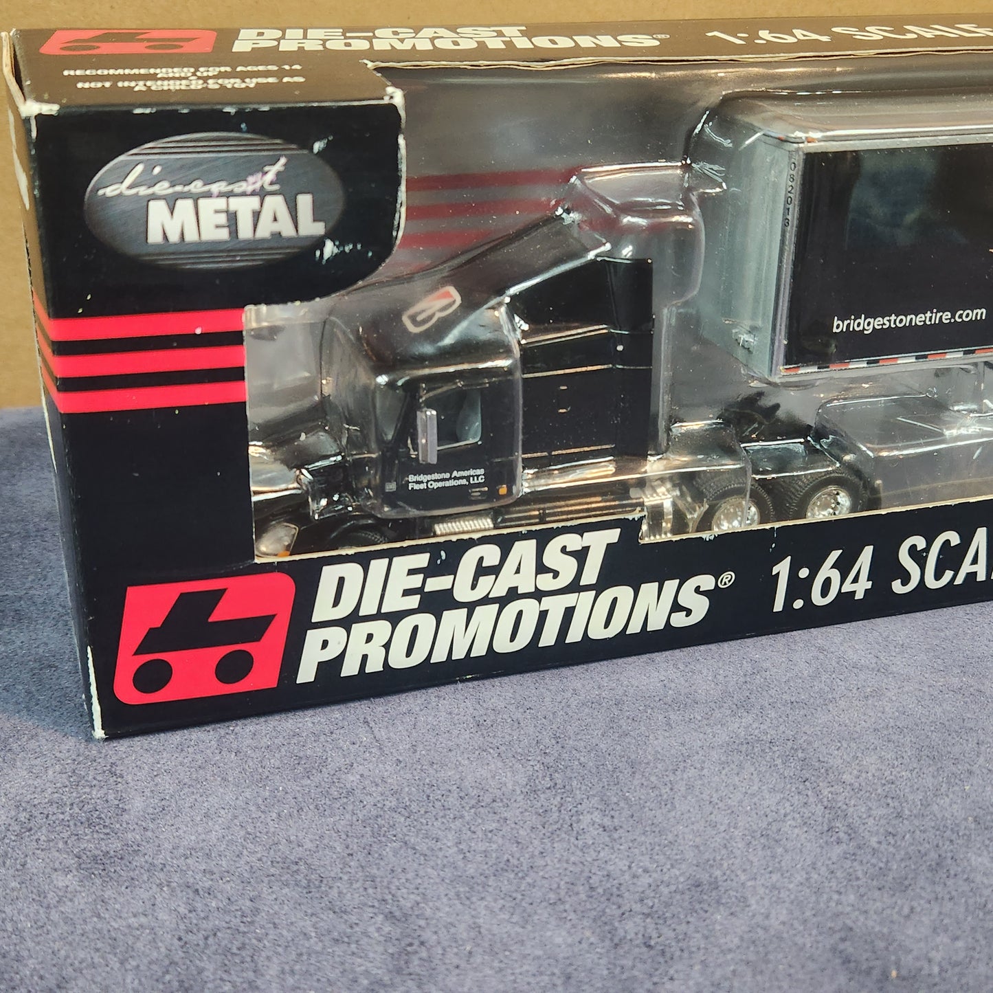Diecast Promotions 1:64 Bridgestone Volvo VNL 630 Mid Roof with Dry Goods Trailer DCP #33658